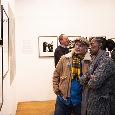 People looking at photography in a gallery.