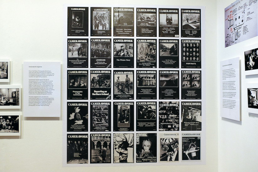 A large poster on the gallery wall, showing the covers of Camerawork magazine. 